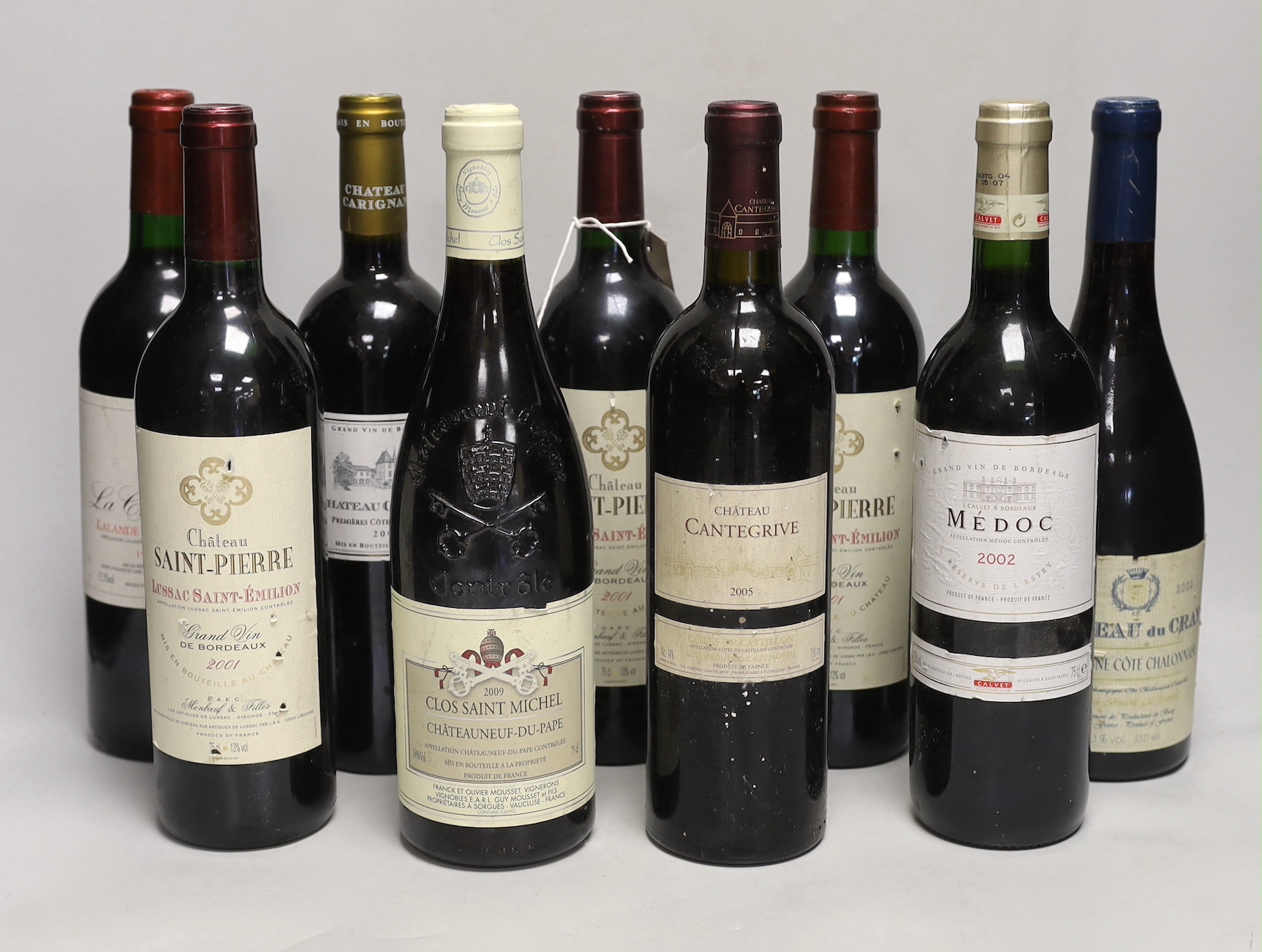 Nine bottles of assorted red wine including three bottles of Lussac Saint Emilion 2001, a bottle Chateauneuf-du-Pape 2009 a bottle of Laplander De Pomerol 1997